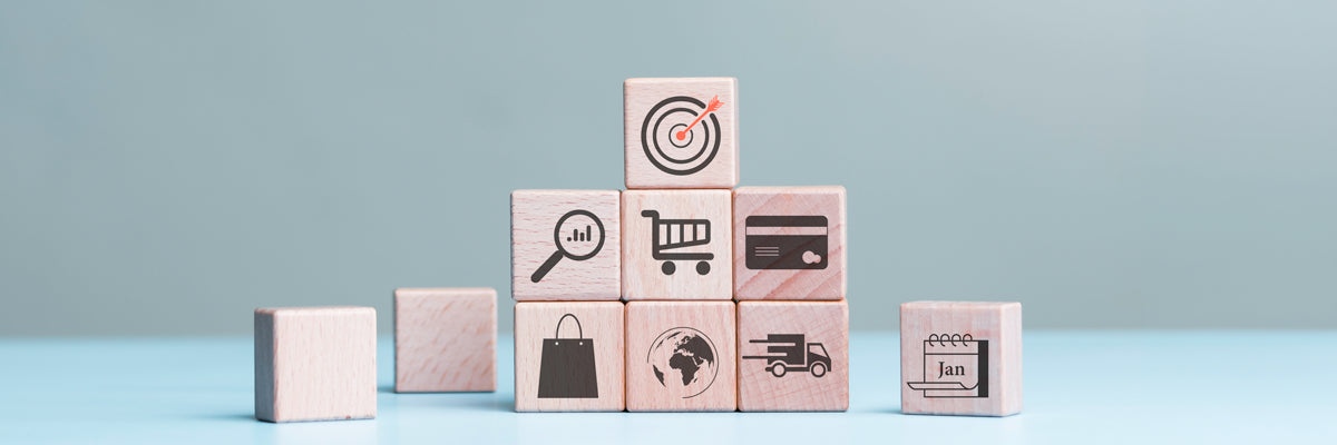Wooden blocks with various icons stacked on a light blue background